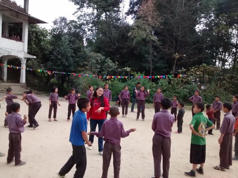 A teacher plays a game of statue with the students