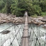 Crossing a hanging bridge on Dri river on Dibang adventure