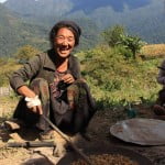 A Monpa lady searing corn